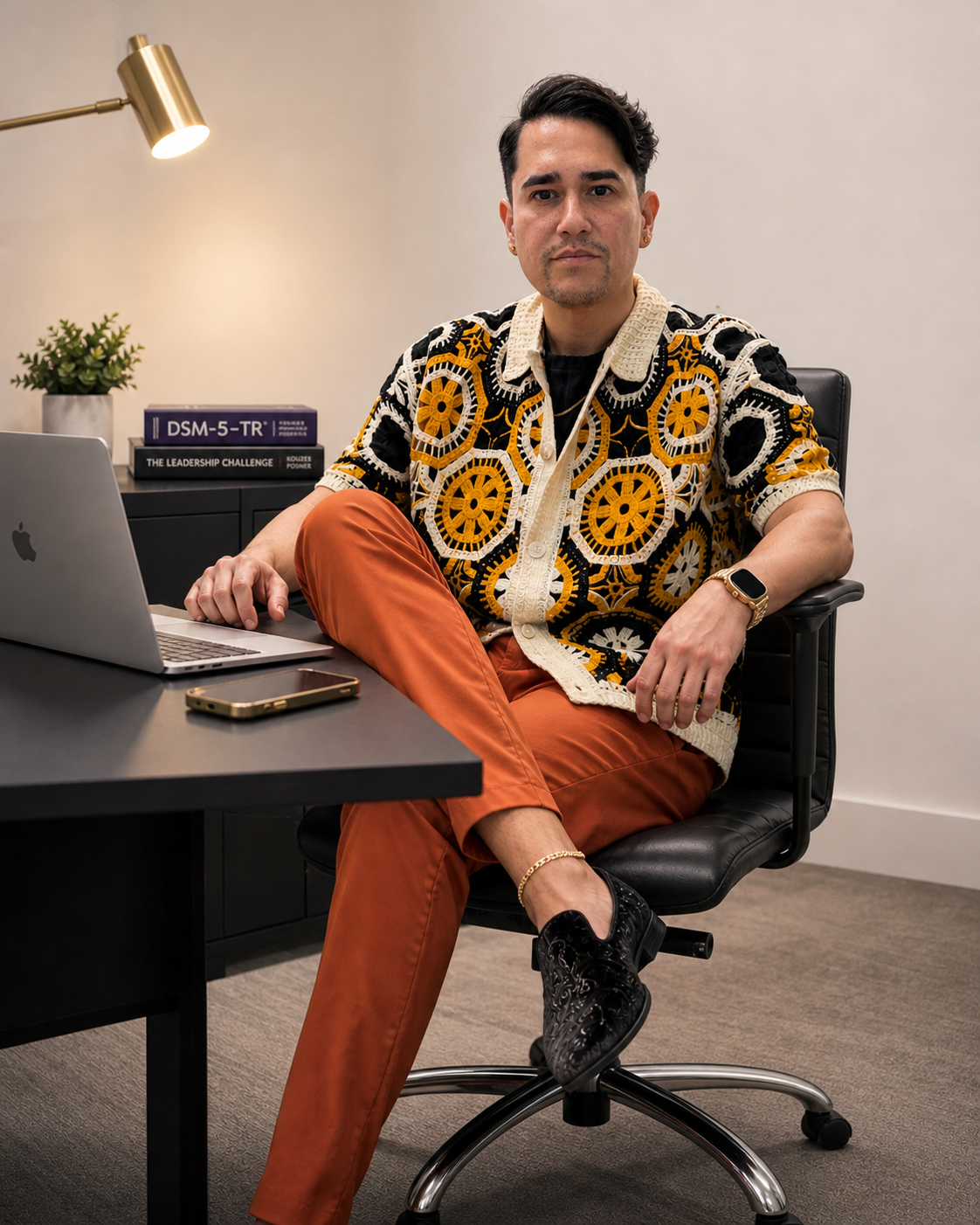 Christopher Collazo seated at a desk in a professional office
